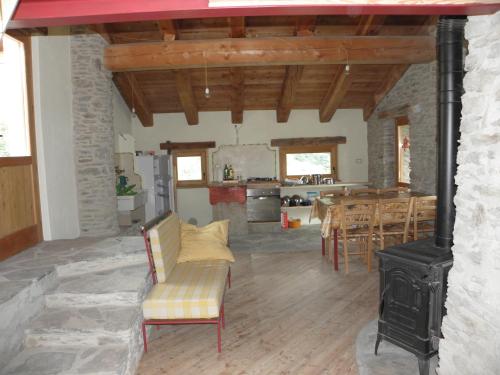 a living room with a fireplace and a stove at La vera casa di Mosè in Marmora