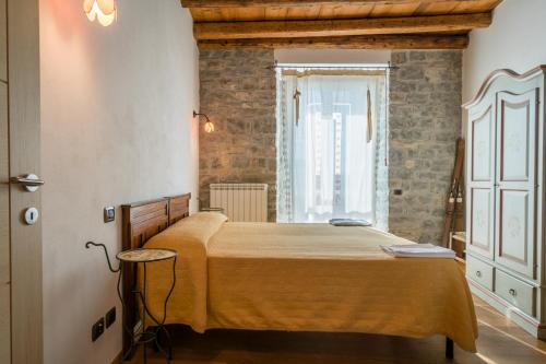 a bedroom with a bed and a window at Borgo San Pietro in Agnone