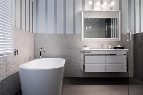 a bathroom with a white tub and a sink at Belle Le Vie in Sassafras