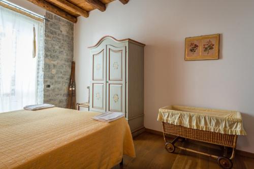 a bedroom with a bed and a dresser in it at Borgo San Pietro in Agnone