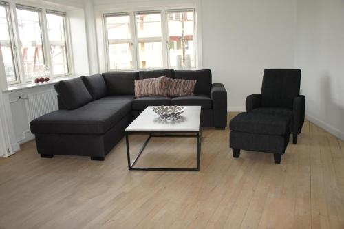 a living room with a couch and two chairs at Strandby Plads ID 186 in Esbjerg