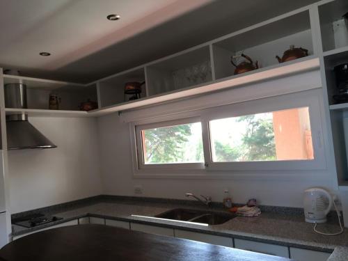 a kitchen with a sink and a window in it at Mirasoles 20 in Las Gaviotas