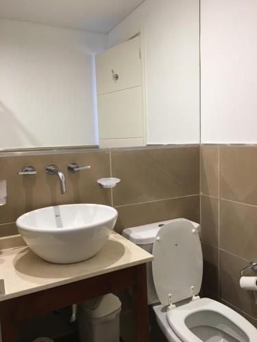 a bathroom with a sink and a toilet at Mirasoles 20 in Las Gaviotas