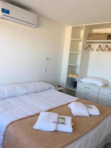 a bedroom with a large bed with towels on it at Mirasoles 20 in Las Gaviotas