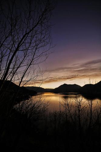 a view of a body of water at sunset at El Jardin in Bellano