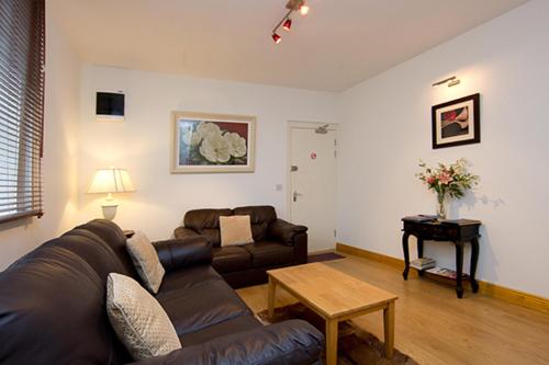 a living room with a couch and a table at Glencourt Apartments in Dublin