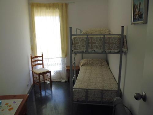 a bedroom with two bunk beds and a chair at Zeus Alexis Frontal in Salou