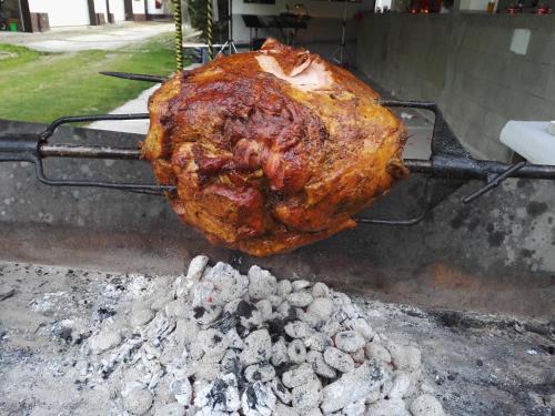 a chicken is being cooked on a grill at Penzion u lípy in Jestřebí