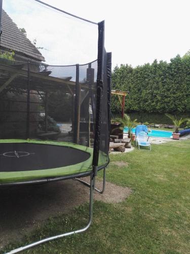 a trampoline in a yard next to a pool at Penzion u lípy in Jestřebí