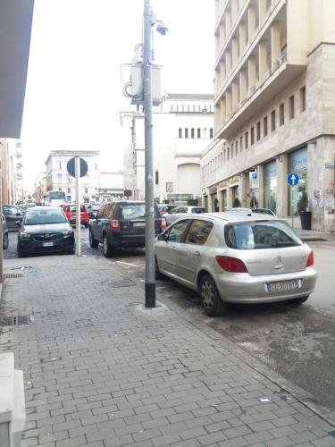 a group of cars parked on a city street at B&B 30 mt dal Duomo in Benevento