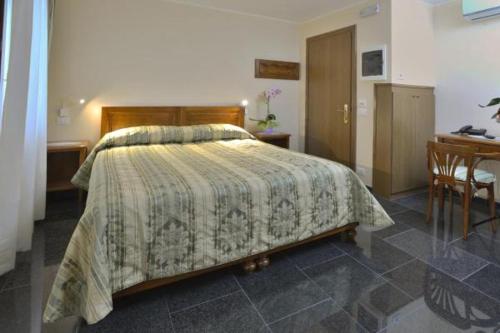 a bedroom with a bed and a desk at Hotel Italia in Sacile