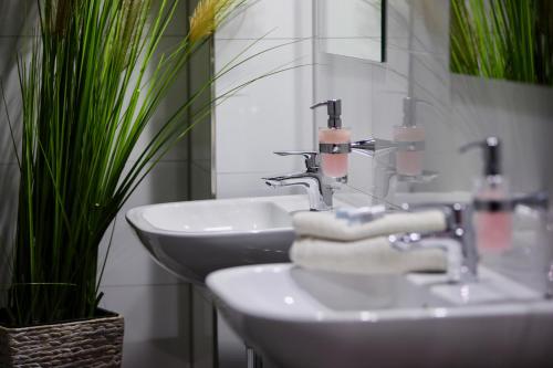 a bathroom with a white sink and a mirror at Elsässer Hostel in Hamburg