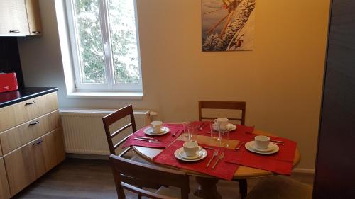 a dining room with a table with a red table cloth at De nussi's chalet 3 in Bach