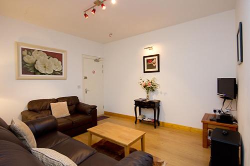 a living room with a couch and a table at Glencourt Apartments in Dublin