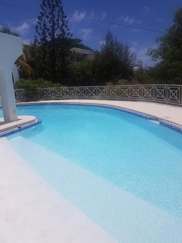 a large swimming pool with blue water at Villa Talassa in Le Morne