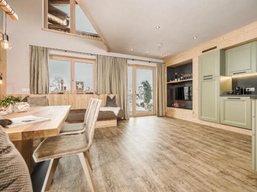 a living room with a dining table and a couch at Zillertaler Hofchalets in Stumm