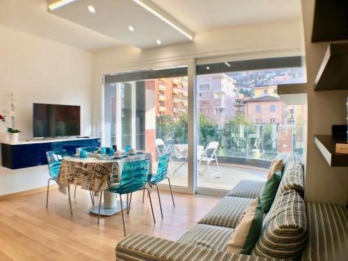 a living room with a table and a couch at Roggia Apartments by Quokka 360 - a stone's throw from Ciani Park in Lugano