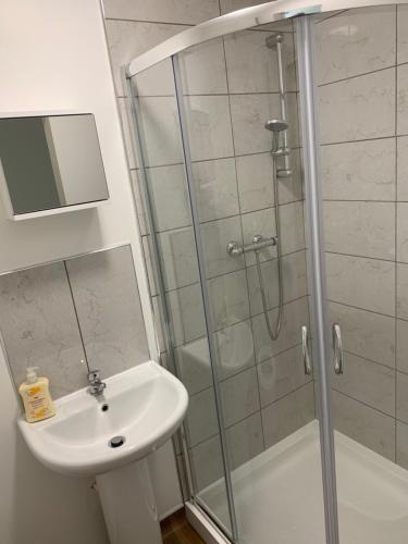 a bathroom with a shower and a sink at Sutton Park Lodge in Sutton Coldfield