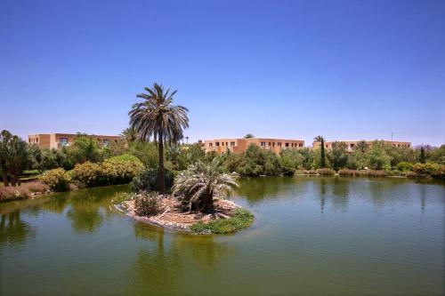 an island in the middle of a lake with a palm tree at Valeria Madina Club - All Inclusive in Marrakech