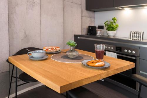 a kitchen with a wooden table with food on it at Timehouse Serviced Apartments in Munich