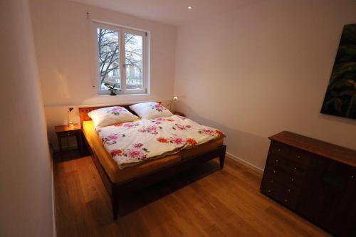 a small bedroom with a bed and a window at Fewo am Josephsplatz in Munich