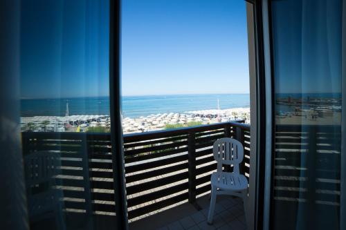 a balcony with two chairs and a view of the ocean at Hotel Miramare in Castiglione della Pescaia