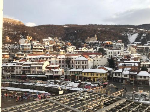 a group of buildings in a city with snow at Theranda Hotel in Prizren