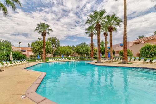 a swimming pool with palm trees in a resort at Sunny Palm Springs Retreat Permit# 4125 in Palm Springs