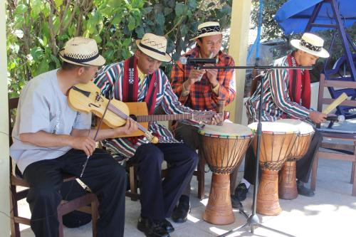 a group of three men playing music and drums at Hôtel - Appartement meublé " LES FLOTS BLEU " in Antananarivo