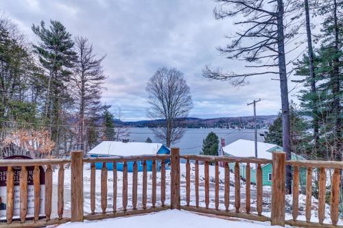 a wooden fence with snow on top of it at Contemporary ADK 5 Bedroom Chalet on Schroon in Schroon Lake