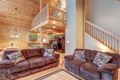 a living room with two couches and a staircase at Contemporary ADK 5 Bedroom Chalet on Schroon in Schroon Lake