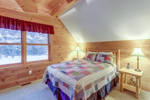a bedroom with a bed in a log cabin at Contemporary ADK 5 Bedroom Chalet on Schroon in Schroon Lake