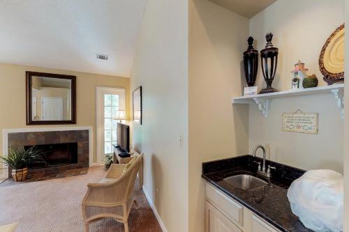 a kitchen with a sink and a fireplace at Evian 285 in Hilton Head Island