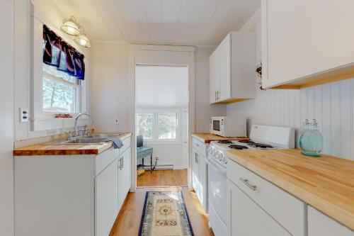 a kitchen with white cabinets and a sink at Toddy Pond Jack in Orland