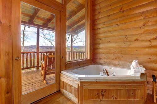 a tub in a wooden bathroom with a window at Kodiak #45 in Sevierville