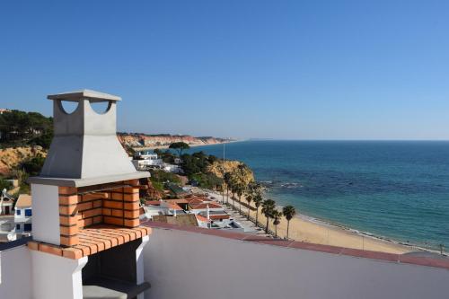 a view of the beach from the balcony of a building at Casa João Bravo in Albufeira