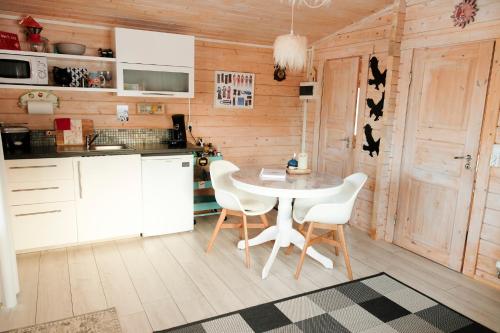 a kitchen with a table and chairs in a room at Kaldá Lyngholt Holiday Homes in Egilsstadir