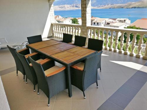 stół i krzesła na balkonie z widokiem na ocean w obiekcie Apartments Villa Anastazija w mieście Pag