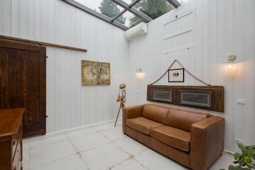 a living room with a couch and a glass ceiling at Villa Marghi in Magione