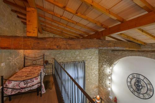 a bedroom with a bed in a stone wall at Villa Marghi in Magione