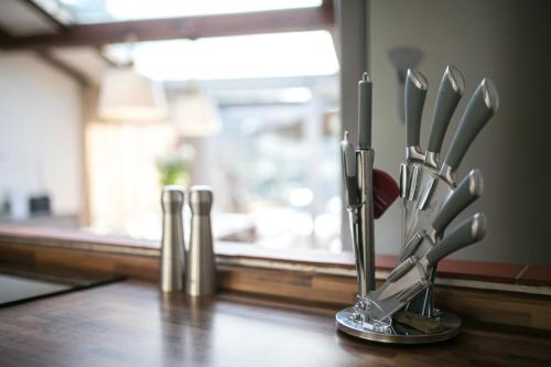 a group of knives in a holder on a table at Villa Marghi in Magione