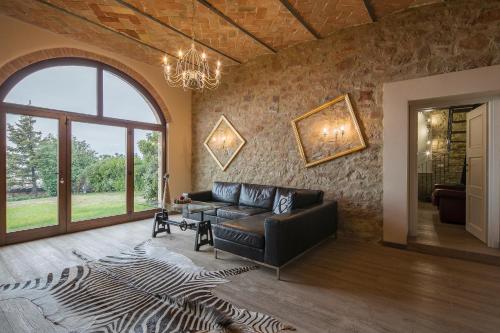 a living room with a couch and a large window at Villa Marghi in Magione