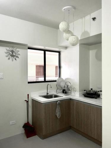 a kitchen with a sink and a window at Stunning Tropical resort condo in Mactan