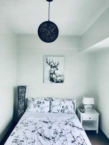 a bedroom with a bed with a deer on it at Stunning Tropical resort condo in Mactan