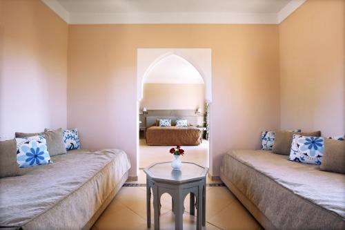 a living room with two couches and a bed at Valeria Madina Club - All Inclusive in Marrakech