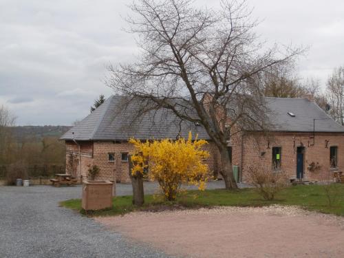 a brick building with a tree in front of it at Chambre d'hôtes L'Ermite in Saint-Algis