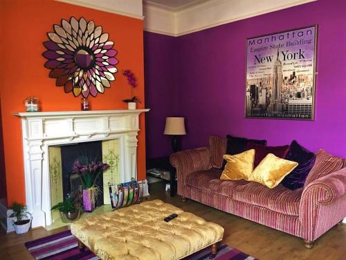 a living room with a couch and a fireplace at Glenmore Guesthouse in Southampton