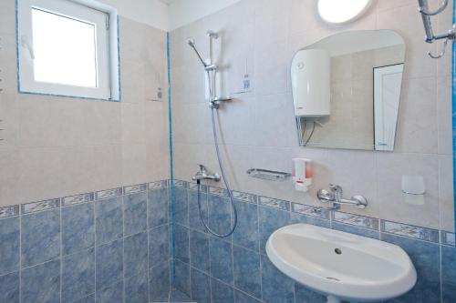 a bathroom with a shower and a sink at Stella di Mare Guest House in Ravda
