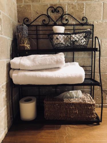 a stack of towels on a rack in a room at Le Coin Savoyard in Combloux