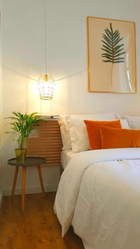 a bedroom with a bed and a table with a plant at Napoli Tree - Lungomare in Naples